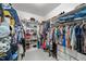 Spacious walk-in closet with built-in shelving, drawers, and hanging racks for ample storage at 905 Neuse Ridge Dr, Clayton, NC 27527