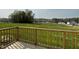 Wooden deck with a view of the green backyard with a line of trees in the distance at 94 Starry Sky Dr, Benson, NC 27504