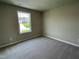 Bright bedroom with a large window and neutral carpet, perfect for relaxation and rest at 94 Starry Sky Dr, Benson, NC 27504