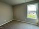 Cozy bedroom with neutral carpet and a bright window offering natural light at 94 Starry Sky Dr, Benson, NC 27504