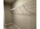 Walk-in closet featuring neutral carpeting and a wire shelving system at 94 Starry Sky Dr, Benson, NC 27504
