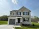 Beautiful two-story home featuring a 1-car garage and neutral-colored siding in a well-manicured yard at 94 Starry Sky Dr, Benson, NC 27504
