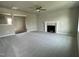 Spacious living room with a fireplace and neutral carpet, ready for new homeowners at 94 Starry Sky Dr, Benson, NC 27504