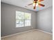 Bedroom with neutral walls and plush carpet and ceiling fan at 1 Edgebrook Cir, Durham, NC 27703
