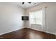 Bedroom featuring light colored walls, wood laminate flooring, and window with curtains at 1 Edgebrook Cir, Durham, NC 27703