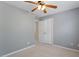 Neutral bedroom featuring a ceiling fan and a double door closet for ample storage at 1 Edgebrook Cir, Durham, NC 27703