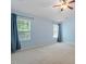 Bright bedroom with ample natural light, neutral walls, plush carpet, and blue curtains at 1 Edgebrook Cir, Durham, NC 27703