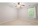 This bedroom features neutral walls, plush carpet, and a ceiling fan for added comfort at 1 Edgebrook Cir, Durham, NC 27703