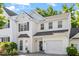 Charming home exterior with manicured bushes, front door and attached garage at 1 Edgebrook Cir, Durham, NC 27703