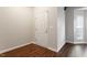 View of the hallway with dark wood flooring and white painted walls at 1 Edgebrook Cir, Durham, NC 27703