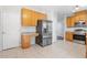 Well-lit kitchen featuring stainless steel refrigerator and ample cabinet storage at 1 Edgebrook Cir, Durham, NC 27703