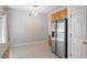 Bright kitchen area with stainless steel refrigerator and ceramic tile flooring at 1 Edgebrook Cir, Durham, NC 27703