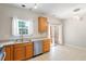 Bright kitchen featuring stainless steel appliances, wood cabinets, and sliding glass door to porch at 1 Edgebrook Cir, Durham, NC 27703