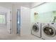 Bright laundry room features modern washer and dryer units for easy convenience at 1 Edgebrook Cir, Durham, NC 27703