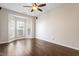 Spacious living room featuring bay windows, ceiling fan and wood laminate flooring at 1 Edgebrook Cir, Durham, NC 27703