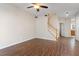 Spacious living room featuring wood laminate flooring, staircase, and ceiling fan at 1 Edgebrook Cir, Durham, NC 27703