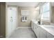 Elegant bathroom featuring double sinks, white cabinetry, glass shower, and modern fixtures at 1012 Country Pasture Cv, Wendell, NC 27591