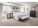 Spacious bedroom with a sitting bench, decorative accents, and two windows for natural light at 1012 Country Pasture Cv, Wendell, NC 27591