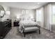 Comfortable bedroom with a sitting bench, dresser, neutral tones, and natural light at 1012 Country Pasture Cv, Wendell, NC 27591