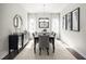 Stylish dining room featuring a modern chandelier, large windows and a decorative accent wall mirror at 1012 Country Pasture Cv, Wendell, NC 27591