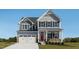 Charming two-story home with a two car garage, a manicured lawn and a striking red front door at 1012 Country Pasture Cv, Wendell, NC 27591