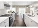 Modern kitchen featuring stainless steel appliances, a marble backsplash and a view into the dining room at 1012 Country Pasture Cv, Wendell, NC 27591