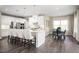 Bright, eat-in kitchen featuring white cabinets, a marble backsplash and dark wood floors at 1012 Country Pasture Cv, Wendell, NC 27591