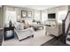 Bright living room featuring comfortable seating, stylish decor, and large windows for ample natural light at 1012 Country Pasture Cv, Wendell, NC 27591