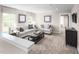 Upstairs living room featuring comfortable seating, carpeted floors, and plenty of natural light at 1012 Country Pasture Cv, Wendell, NC 27591