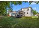 Spacious backyard with a well-maintained lawn, a large wooden deck, and shade structures for outdoor living at 1028 Bellenden Dr, Durham, NC 27713