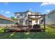 Expansive backyard featuring a spacious deck with seating, grill, shade structures, and well-manicured lawn at 1028 Bellenden Dr, Durham, NC 27713