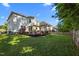 Large backyard with a wooden deck, sunshade, and lush green lawn, perfect for outdoor activities and relaxation at 1028 Bellenden Dr, Durham, NC 27713