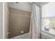 Bathroom tub/shower combo with decorative beige and gray patterned shower curtain at 1028 Bellenden Dr, Durham, NC 27713