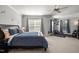 Spacious bedroom with blue bedding, neutral walls, ceiling fan, and a home gym space featuring a weight bench at 1028 Bellenden Dr, Durham, NC 27713