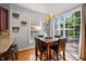 Bright dining area with a marble table, stylish light fixture, and sliding doors to the outdoor space at 1028 Bellenden Dr, Durham, NC 27713