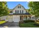 Charming two-story home with a welcoming front porch and a well-maintained lawn at 1028 Bellenden Dr, Durham, NC 27713