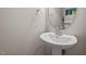Modern half bathroom featuring a pedestal sink and elegant fixtures at 1028 Bellenden Dr, Durham, NC 27713