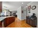 Open kitchen flows into the living room offering dark wood cabinets and granite counters at 1028 Bellenden Dr, Durham, NC 27713