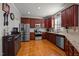 Well-equipped kitchen featuring stainless steel appliances, custom cabinets, and granite countertops at 1028 Bellenden Dr, Durham, NC 27713