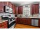 A kitchen that includes a stainless steel stove, granite counters, and stylish backsplash at 1028 Bellenden Dr, Durham, NC 27713