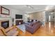 Comfortable living room with a fireplace, wood floors, and modern furnishings at 1028 Bellenden Dr, Durham, NC 27713