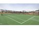 New tennis court surrounded by fence, with new homes in the background at 1036 Channel Drop Lp, Zebulon, NC 27597