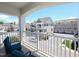 Relaxing balcony view with blue cushioned chairs and white railing overlooking neighborhood street at 10529 Sablewood Dr # 116, Raleigh, NC 27617