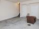 Spacious unfinished basement area with concrete floor, neutral walls, and two white doors at 10529 Sablewood Dr # 116, Raleigh, NC 27617
