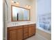 Bathroom featuring double sinks, a large mirror, and natural light from a window at 10529 Sablewood Dr # 116, Raleigh, NC 27617