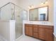 Bathroom with a glass-enclosed shower, double vanity, and a large mirror at 10529 Sablewood Dr # 116, Raleigh, NC 27617