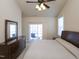 Bedroom with a ceiling fan, sliding glass door, and a view to an outdoor patio at 10529 Sablewood Dr # 116, Raleigh, NC 27617