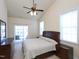 Bright bedroom featuring a ceiling fan, balcony access, and neutral decor at 10529 Sablewood Dr # 116, Raleigh, NC 27617