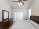 Bright bedroom featuring a ceiling fan, two windows, and neutral colored walls at 10529 Sablewood Dr # 116, Raleigh, NC 27617