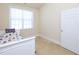 Bright bedroom featuring a cozy bed with a colorful patterned cover, carpeted floor, and a window providing natural light at 10529 Sablewood Dr # 116, Raleigh, NC 27617